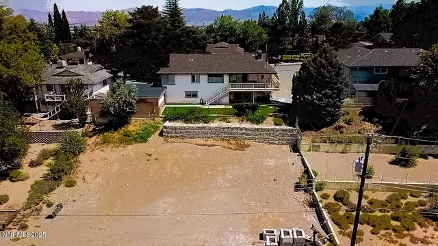an aerial view of a house with a yard