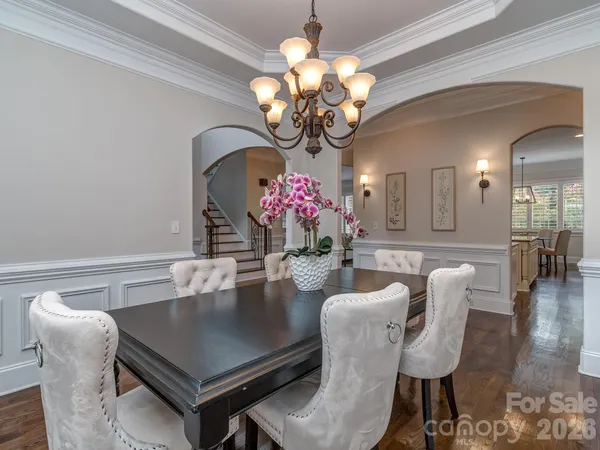 a dining room with furniture and chandelier