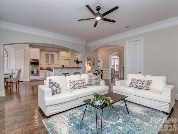 a living room with furniture and view of kitchen
