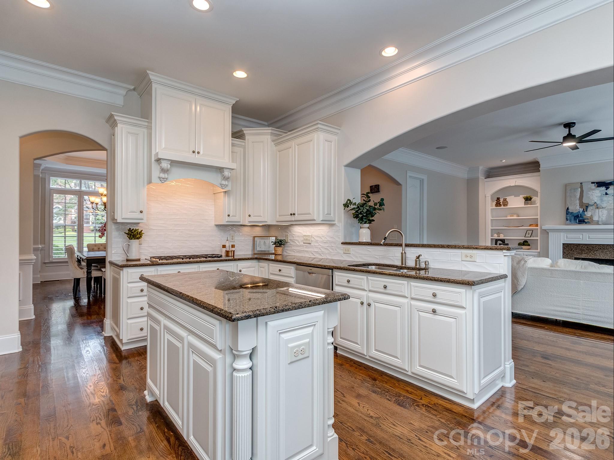8208 Wingard Road Waxhaw, NC 28173 - Photo 15 of 41 a kitchen with stainless steel appliances granite countertop a sink stove and wooden floor
