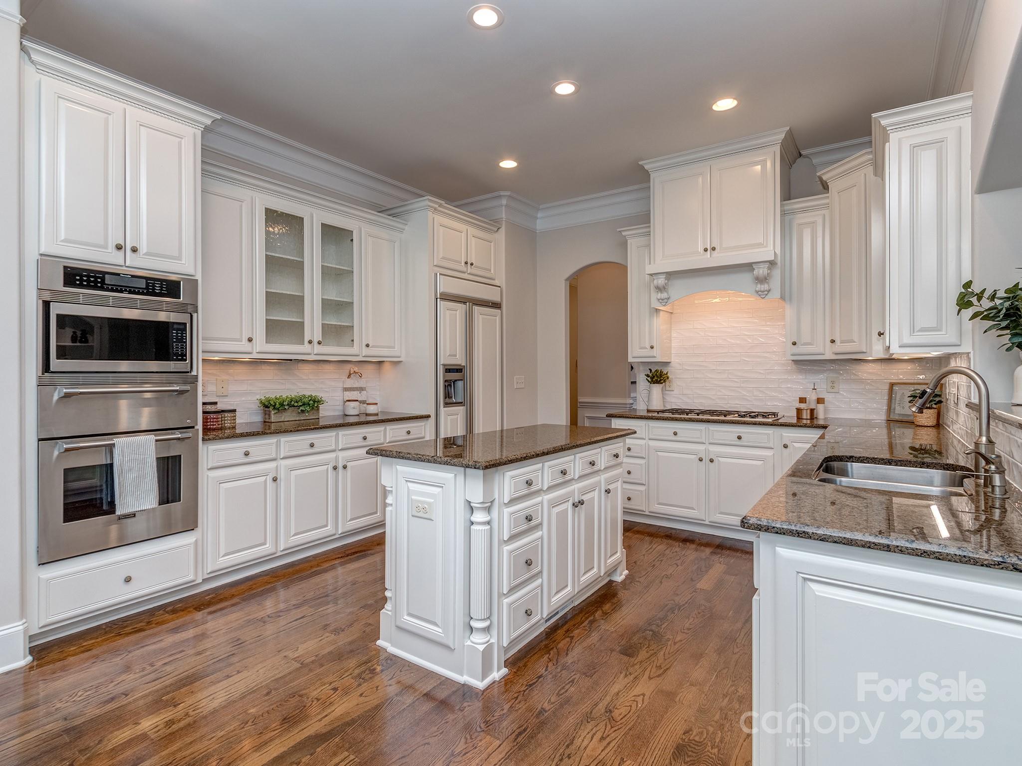 8208 Wingard Road Waxhaw, NC 28173 - Photo 15 of 41 a kitchen with stainless steel appliances granite countertop a stove sink and cabinets