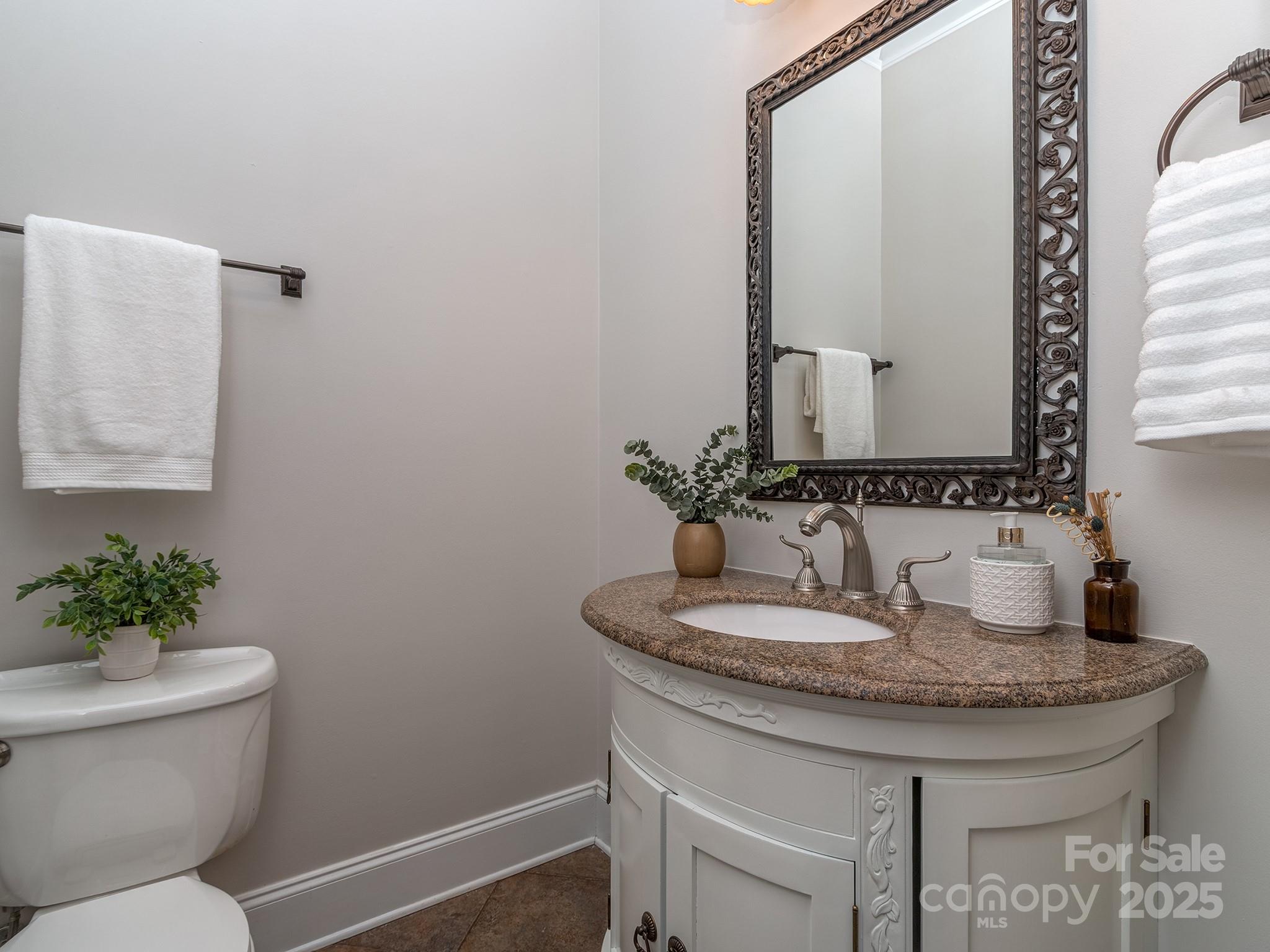 8208 Wingard Road Waxhaw, NC 28173 - Photo 17 of 41 a bathroom with a toilet sink and mirror