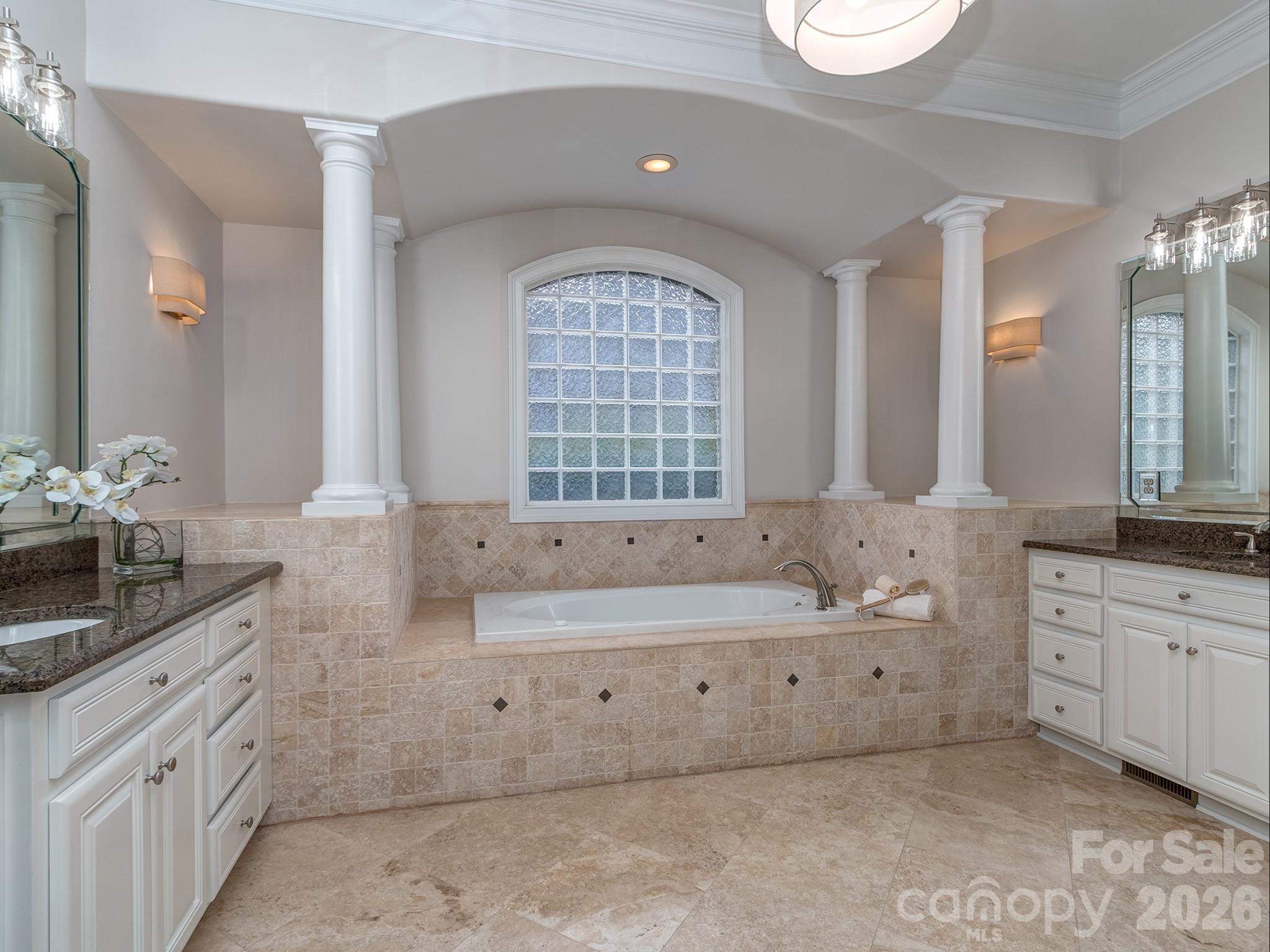 8208 Wingard Road Waxhaw, NC 28173 - Photo 20 of 41 a spacious bathroom with double sink a large mirror and a bathtub