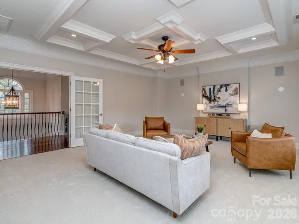 a living room with furniture and a chandelier
