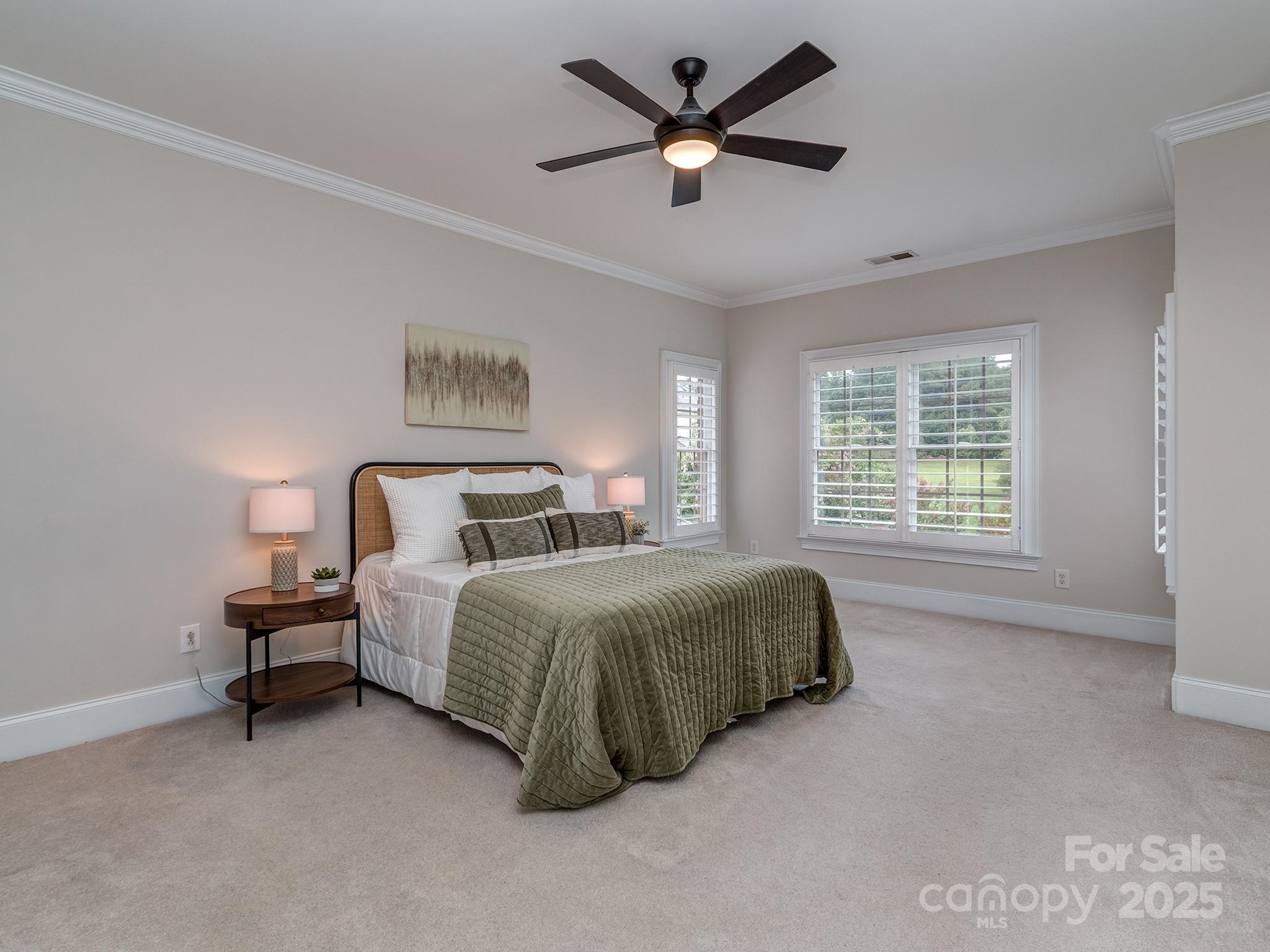 8208 Wingard Road Waxhaw, NC 28173 - Photo 26 of 41 a spacious bedroom with a bed a window and a chandelier