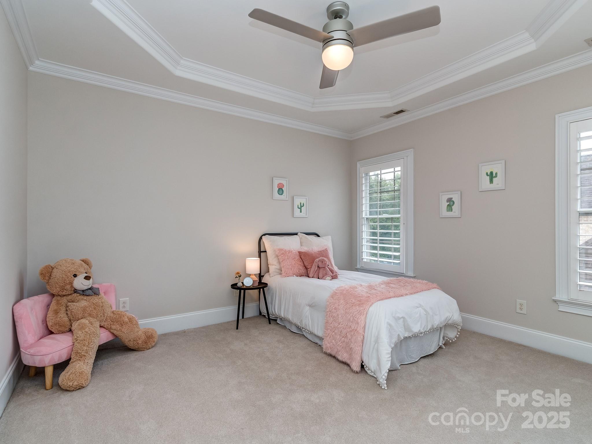 8208 Wingard Road Waxhaw, NC 28173 - Photo 28 of 41 a bedroom with a bed and a chandelier