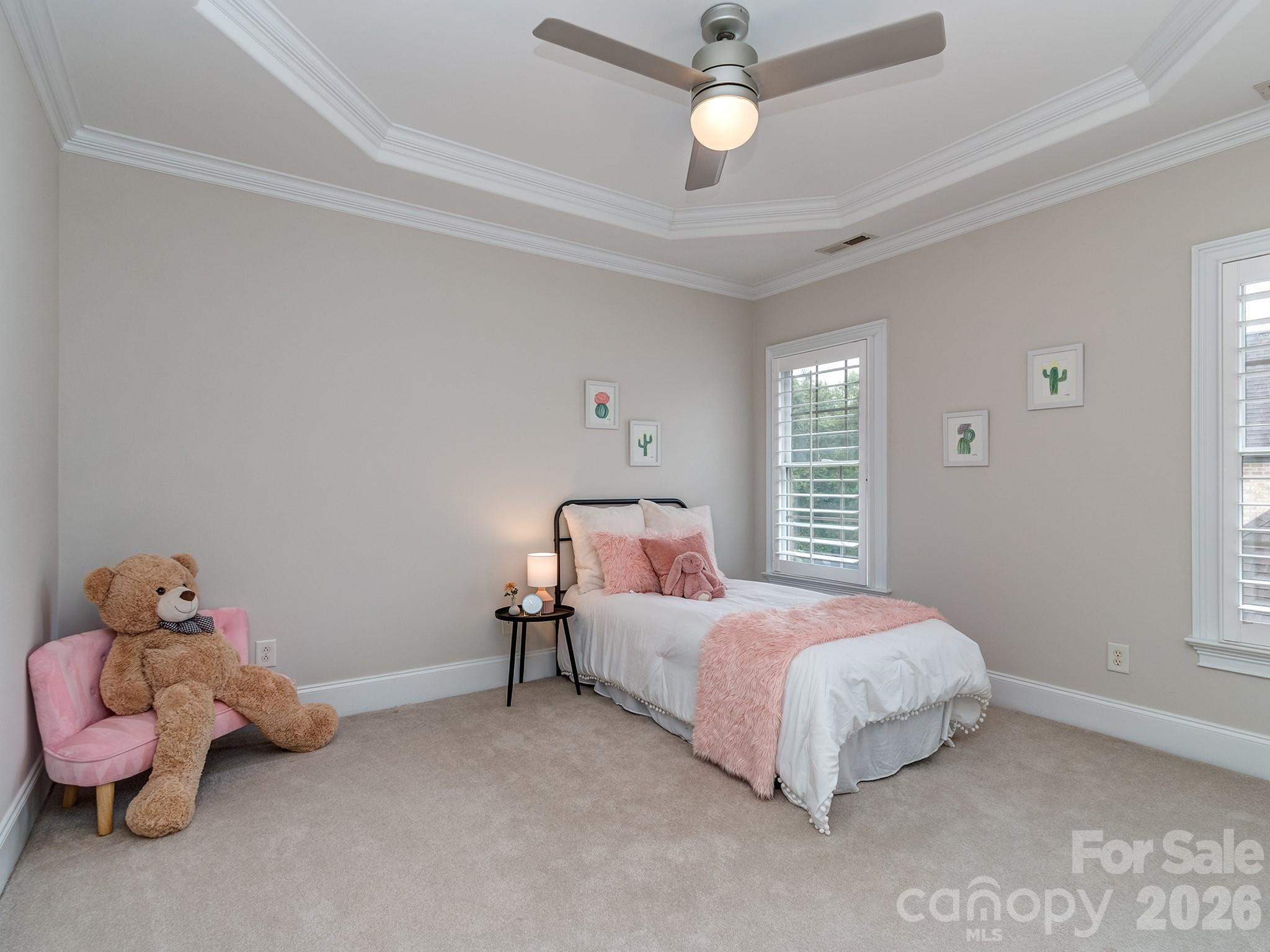 8208 Wingard Road Waxhaw, NC 28173 - Photo 29 of 41 a bedroom with a bed and a chandelier
