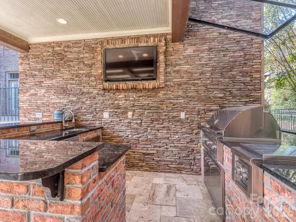a bathroom with a granite countertop sink a toilet and a shower