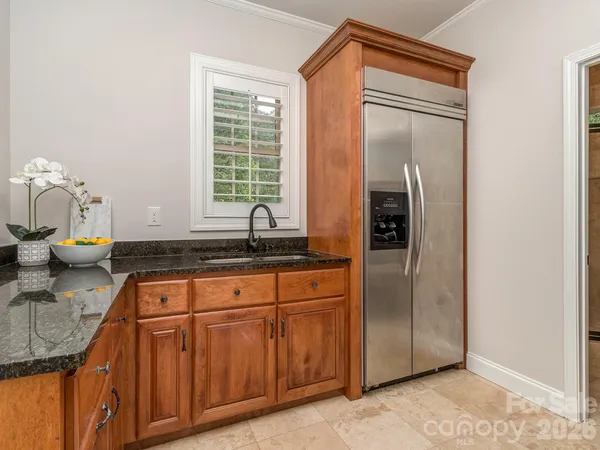 a kitchen with stainless steel appliances granite countertop a refrigerator and a sink