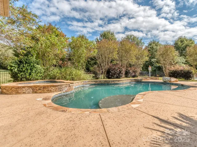 a view of swimming pool with a yard