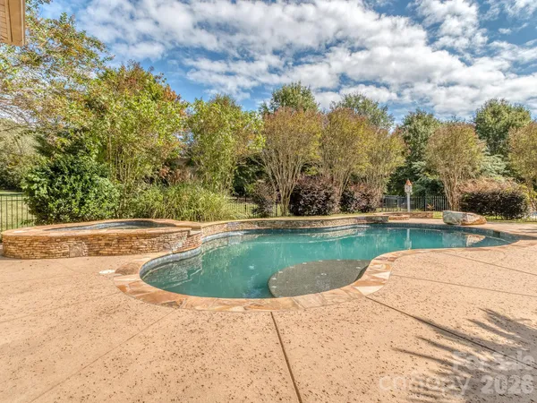 a view of swimming pool with a yard