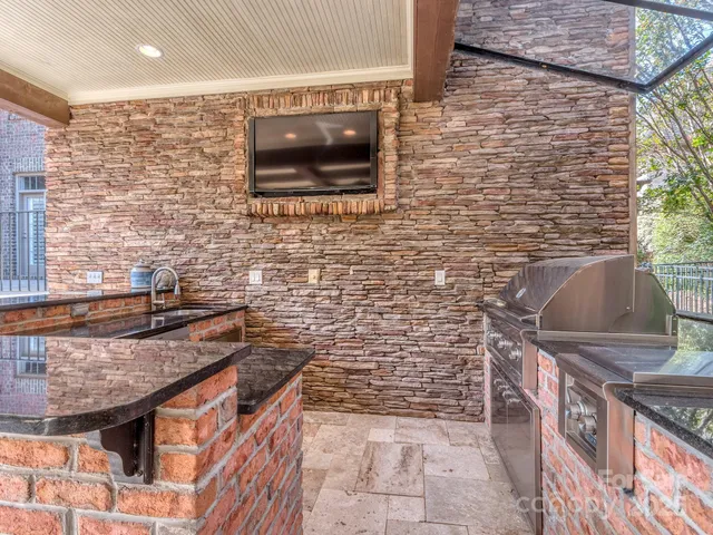 a bathroom with a granite countertop sink a toilet and a shower