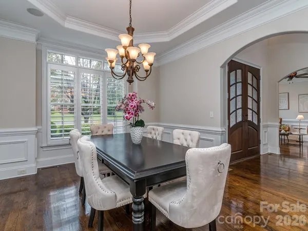 a view of a dining room with furniture wooden floor and chandelier