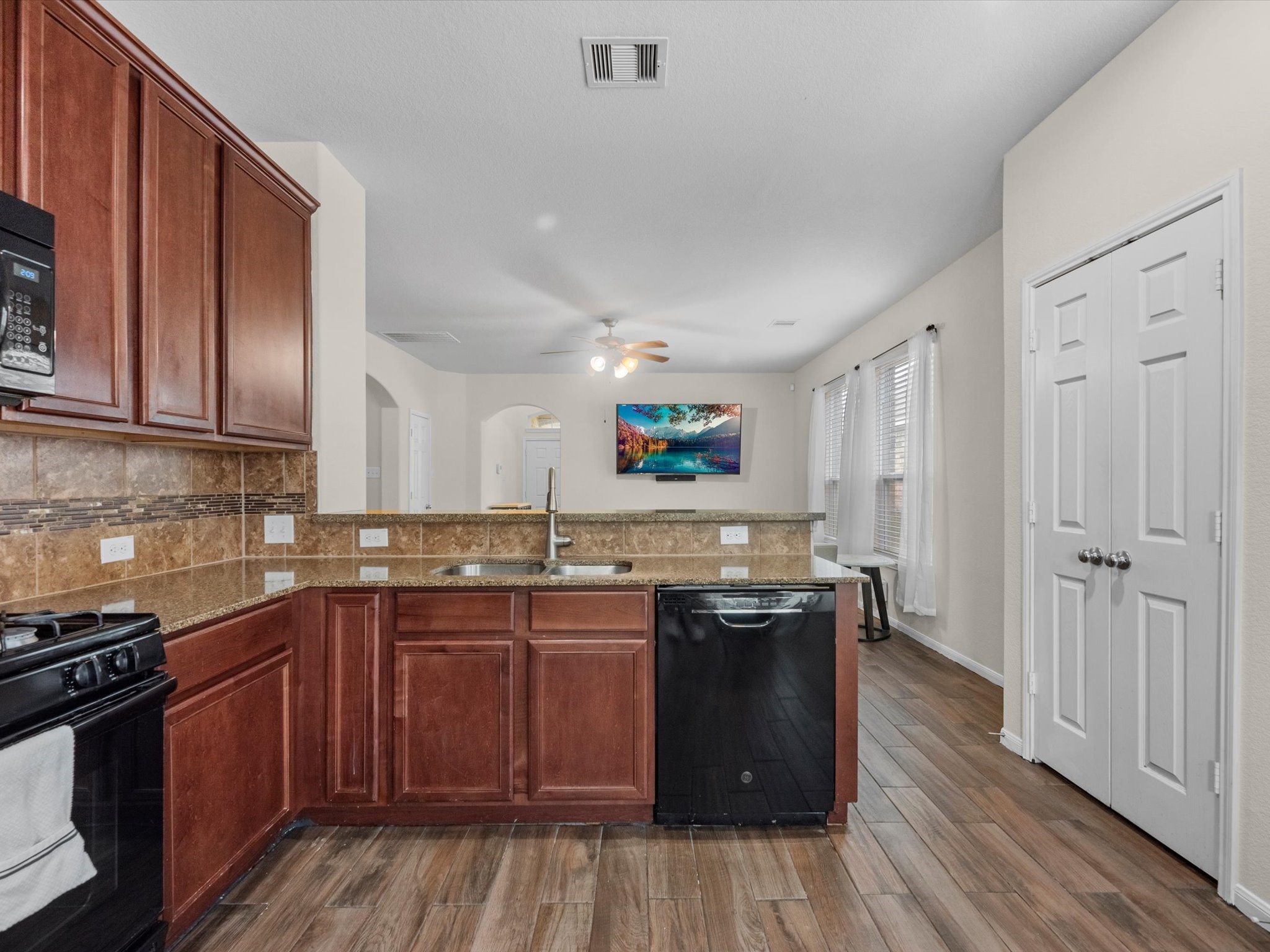 21554 Rainfall Park Drive Spring, TX 77388 - Photo 9 of 33 This kitchen features plenty of counter space and has a breakfast bar. It opens to the bright, airy living space.
