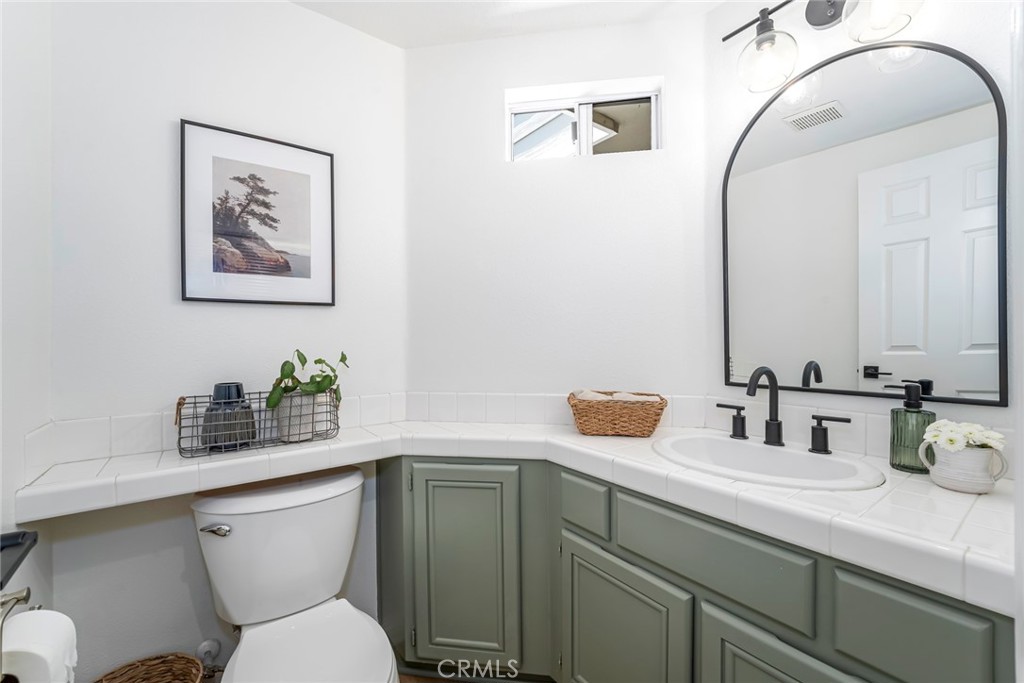 33144 Ocean Ridge Dana Point, CA 92629 - Photo 16 of 45 a bathroom with a toilet sink and mirror