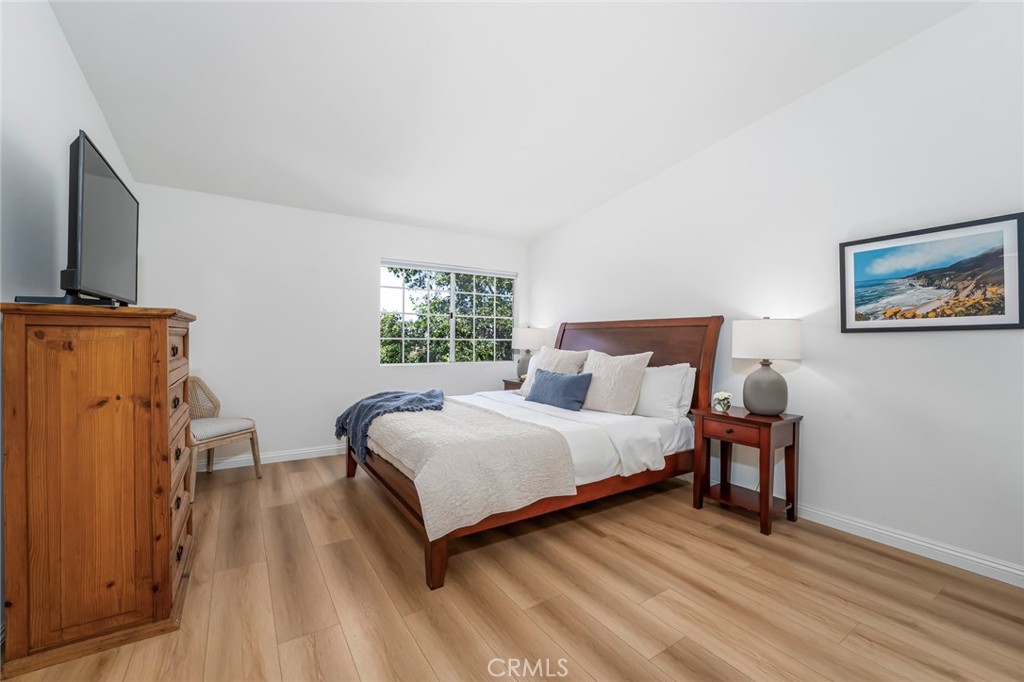 33144 Ocean Ridge Dana Point, CA 92629 - Photo 25 of 45 a bedroom with a bed and wooden floor
