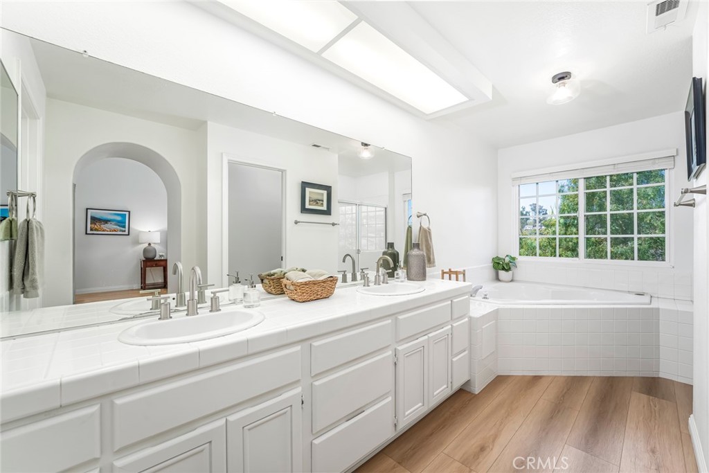 33144 Ocean Ridge Dana Point, CA 92629 - Photo 27 of 45 a bathroom with a granite countertop sink mirror and bathtub