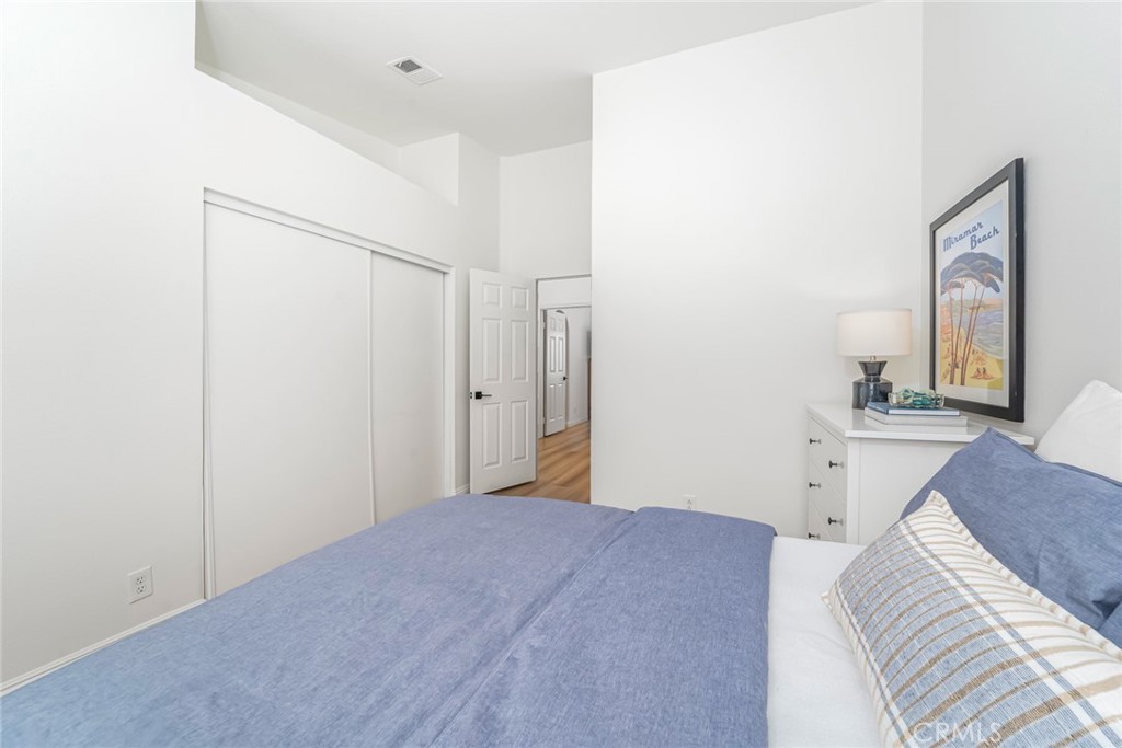 33144 Ocean Ridge Dana Point, CA 92629 - Photo 33 of 45 a bedroom with a bed and a chandelier