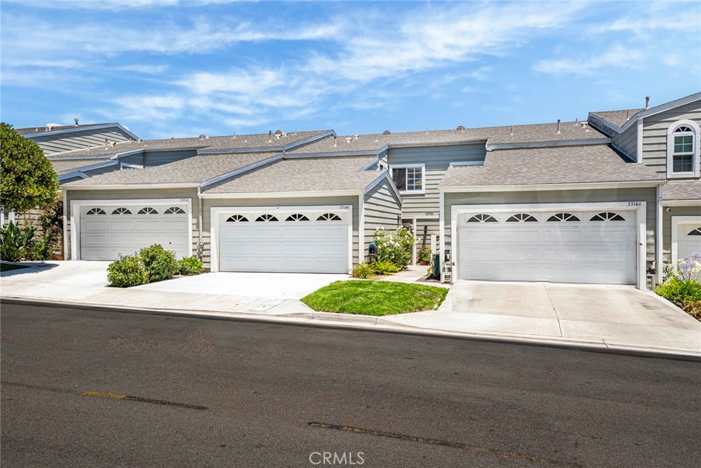 33144 Ocean Ridge Dana Point, CA 92629 - Photo 40 of 45 a front view of a house with a yard and garage