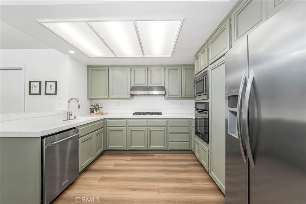 33144 Ocean Ridge Dana Point, CA 92629 - Photo 7 of 45 a kitchen with stainless steel appliances granite countertop a sink and a refrigerator