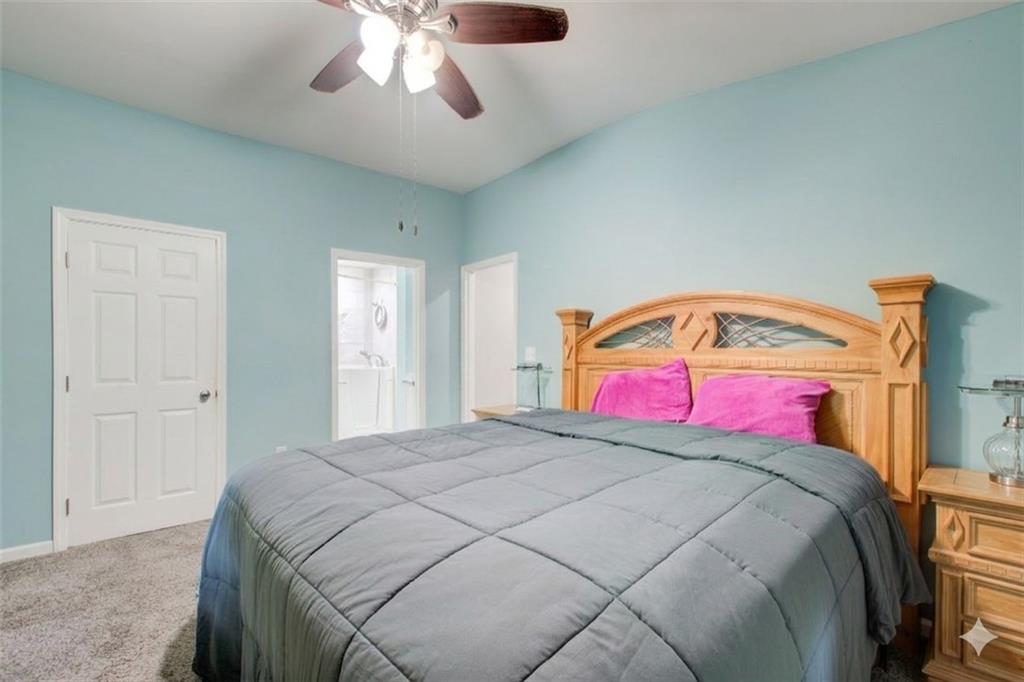 2619 Old Toney Road Ellenwood, GA 30294 - Photo 17 of 32 a bedroom with a bed and a chandelier