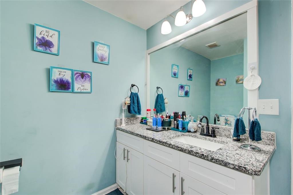 2619 Old Toney Road Ellenwood, GA 30294 - Photo 19 of 32 a bathroom with a granite countertop sink with a mirror