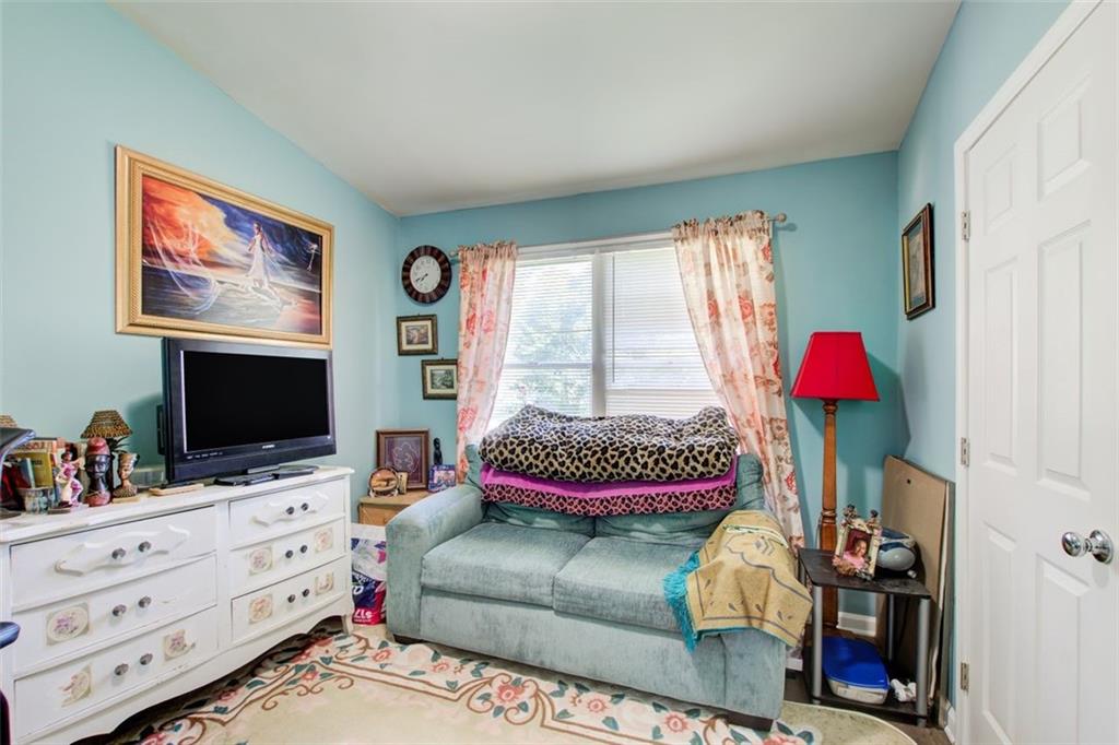 2619 Old Toney Road Ellenwood, GA 30294 - Photo 20 of 32 a bedroom with furniture and a flat screen tv