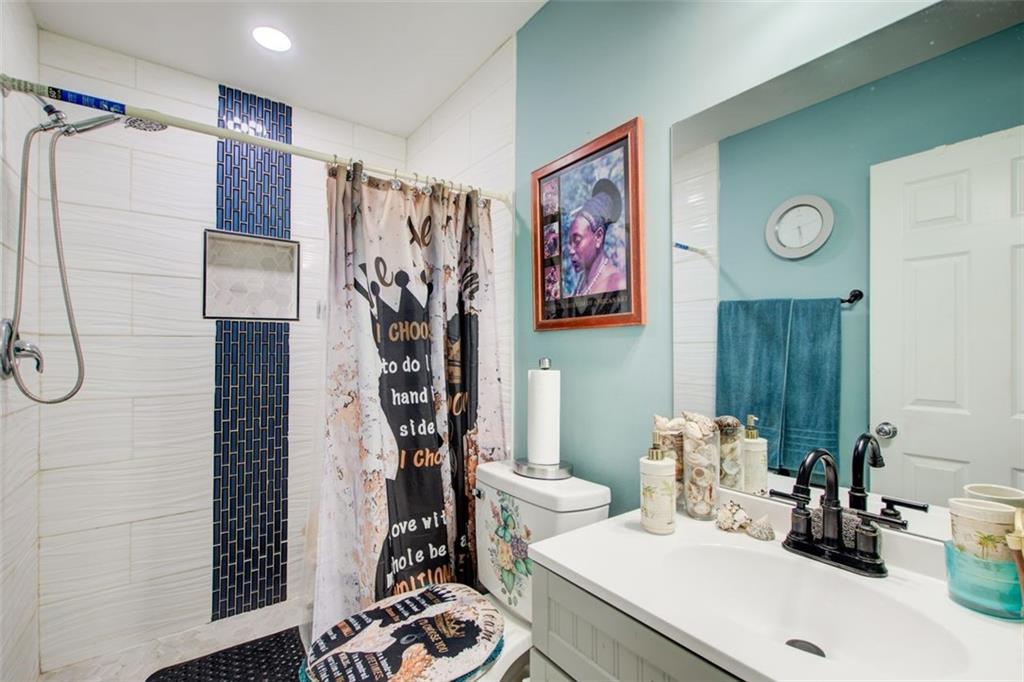 2619 Old Toney Road Ellenwood, GA 30294 - Photo 24 of 32 a bathroom with a sink a toilet and shower curtain