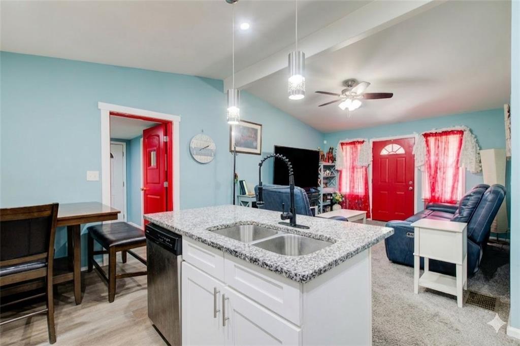 2619 Old Toney Road Ellenwood, GA 30294 - Photo 8 of 32 a kitchen with a sink cabinets and chairs