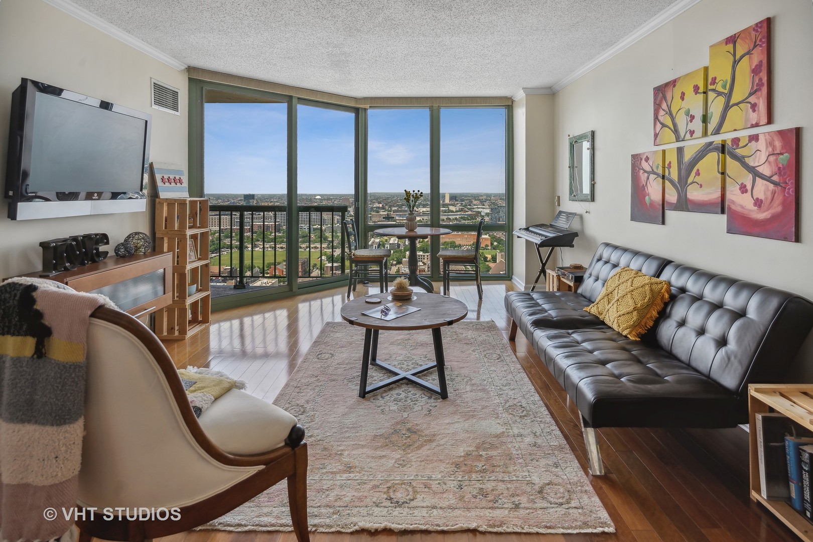 111 West Maple Street, Unit 3011 Chicago, IL 60610 - Photo 5 of 11 a living room with furniture a flat screen tv and a floor to ceiling window