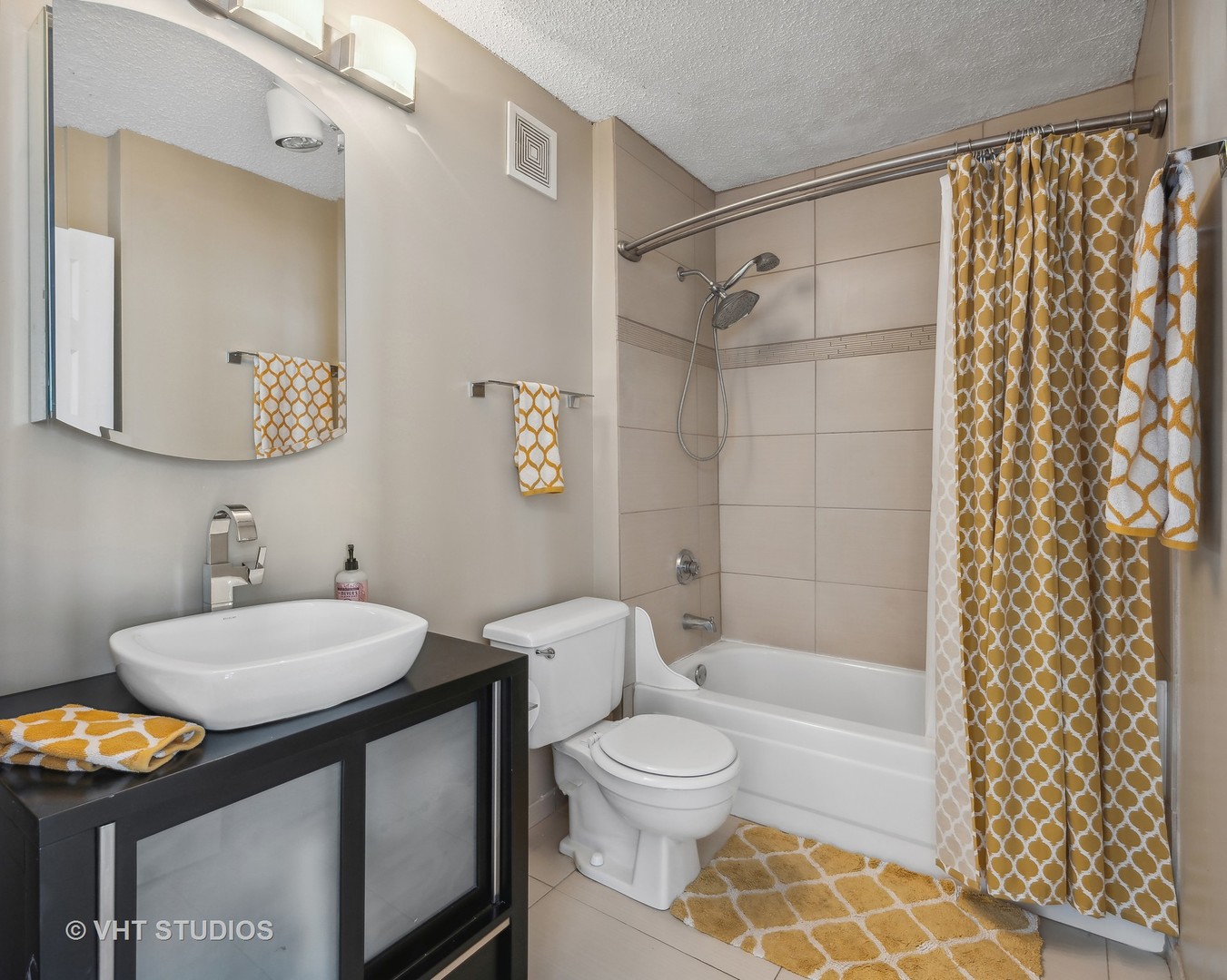 111 West Maple Street, Unit 3011 Chicago, IL 60610 - Photo 8 of 11 a bathroom with a sink toilet a mirror and shower