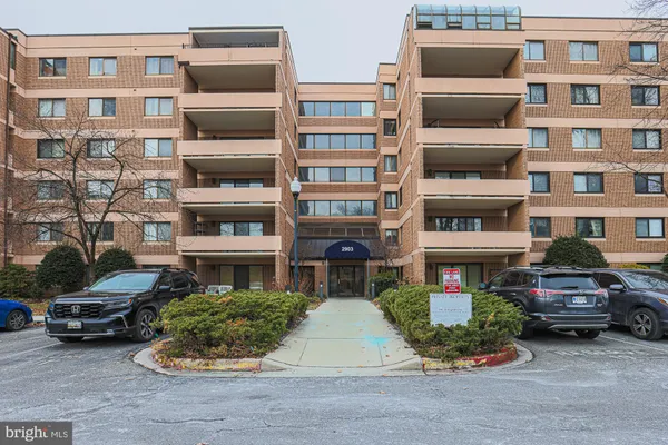 a front view of a building with parking space