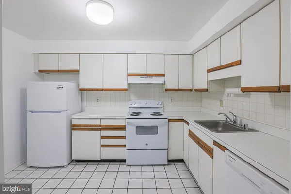 a kitchen with a stove sink and cabinets