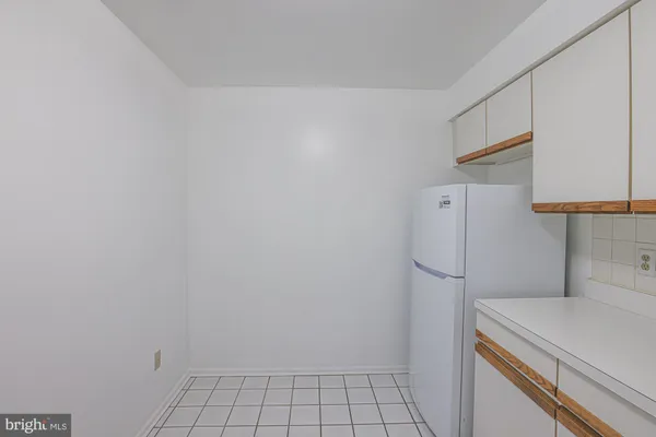 a view of a storage and utility room with washer and dryer