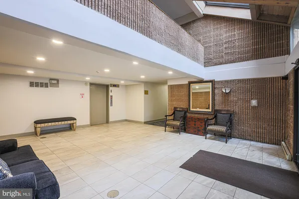 a lobby with furniture and a rug
