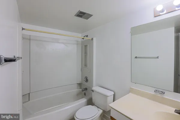 a bathroom with a toilet and a bathtub