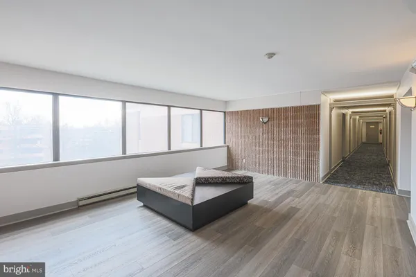 a spacious bedroom with a large bed and a large window