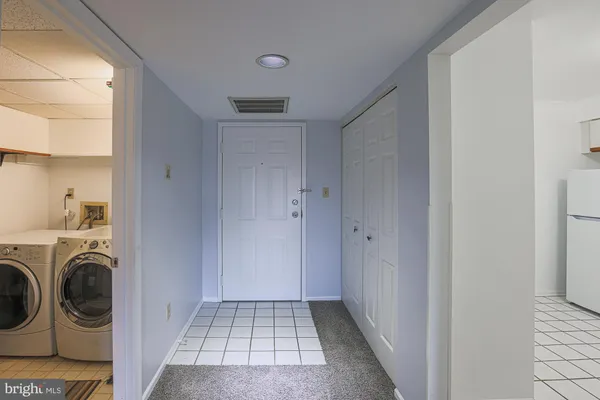 a view of a hallway with washer and dryer