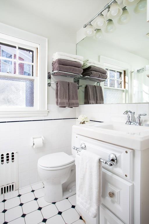 98 Clark Road Brookline, MA 02445 - Photo 11 of 12 a bathroom with a sink a toilet and a mirror