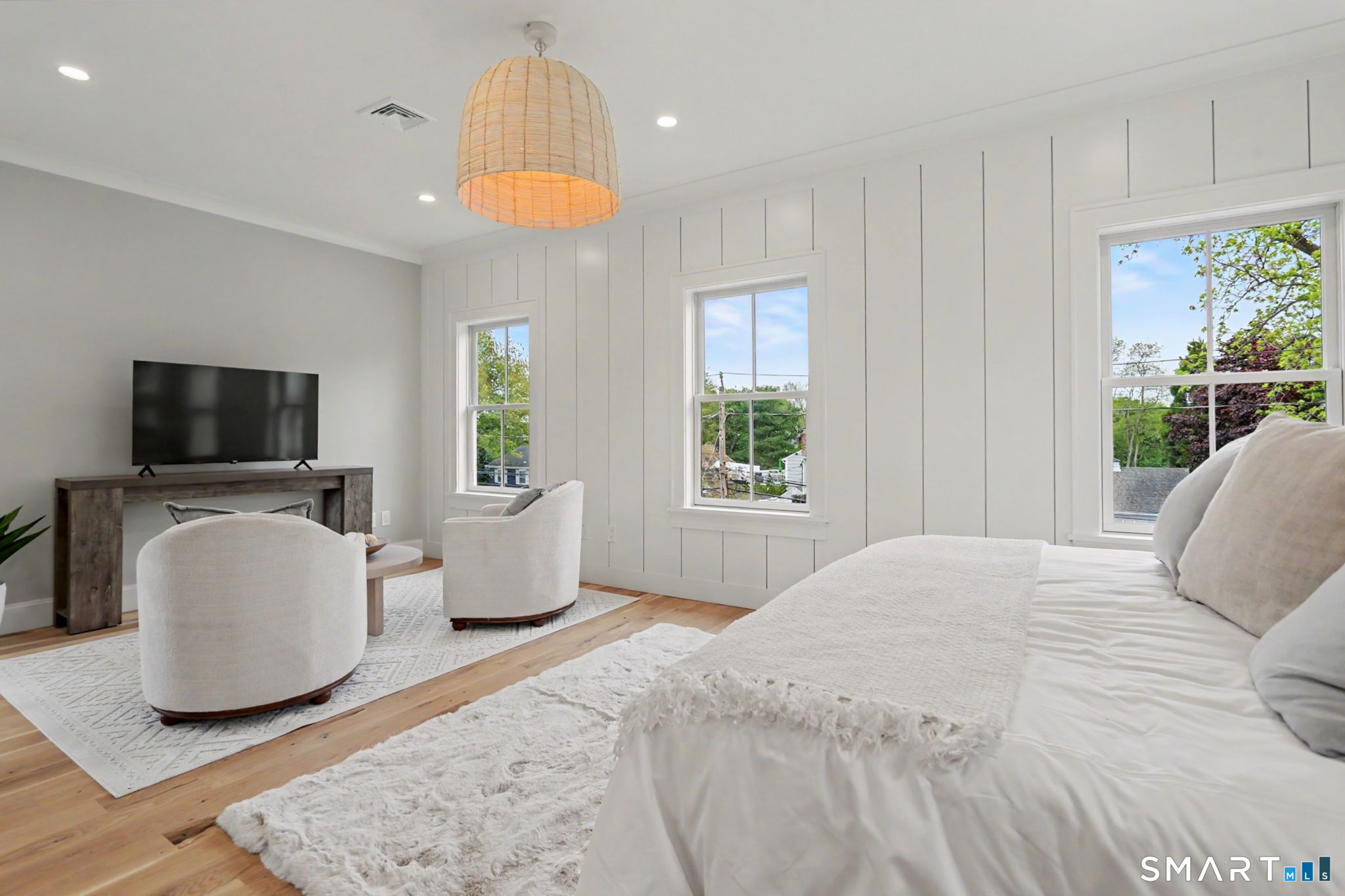 96 Clinton Street Fairfield, CT 06824 - Photo 20 of 34 a bedroom with a white bed and a flat screen tv