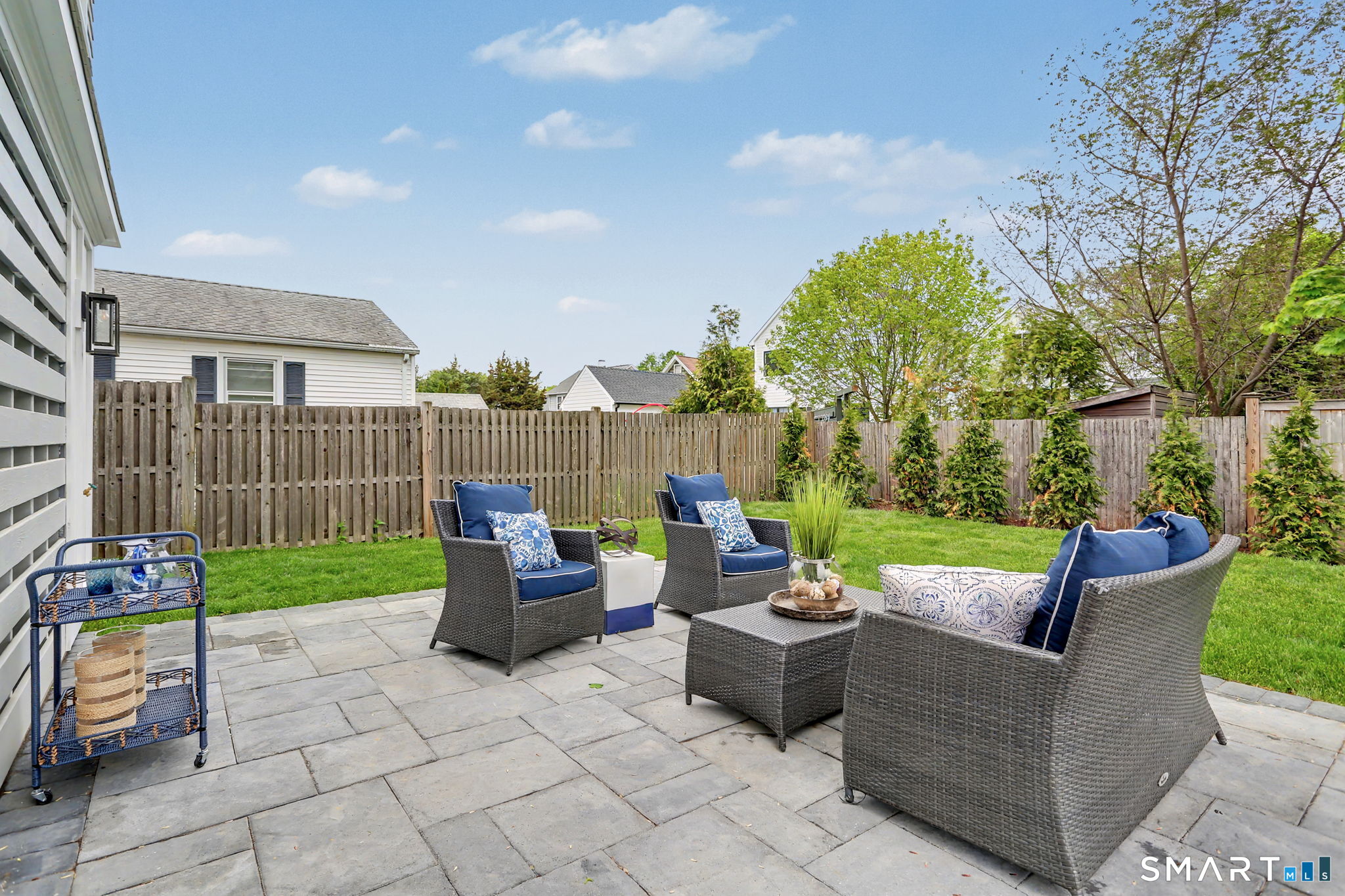96 Clinton Street Fairfield, CT 06824 - Photo 31 of 34 a view of a patio with couches and a fire pit