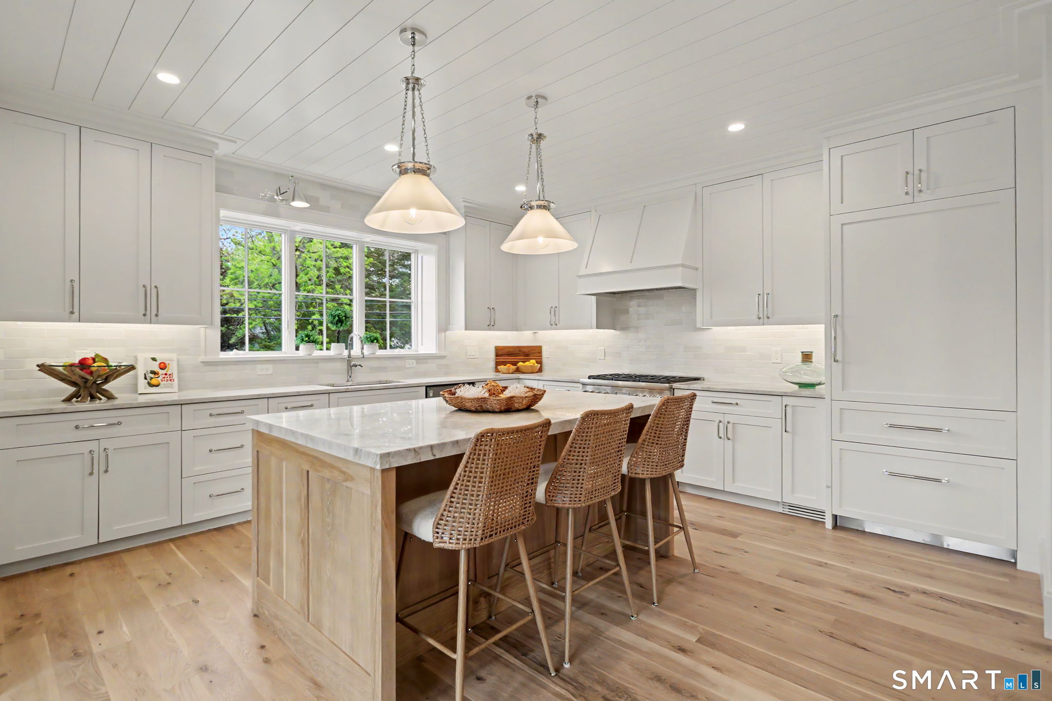 96 Clinton Street Fairfield, CT 06824 - Photo 6 of 34 a kitchen with a center island white cabinets and stainless steel appliances
