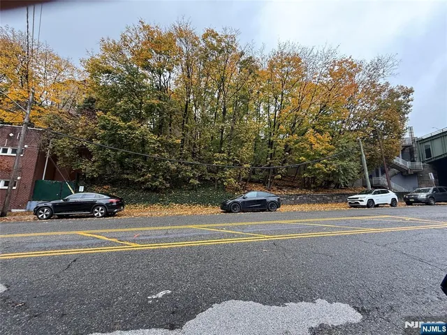 a view of street with parked cars