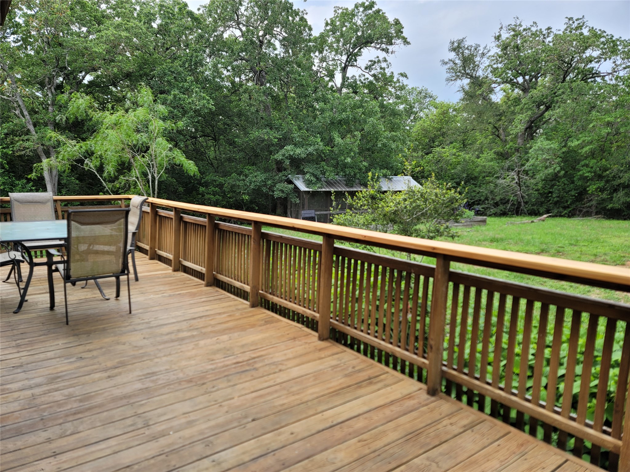 281 Earl Callahan Road, Unit A Cedar Creek, TX 78612 - Photo 37 of 39 a balcony with wooden floor and outdoor space