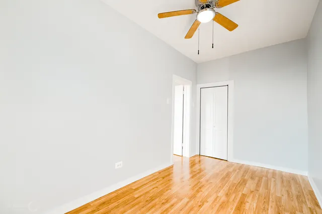 a view of empty room with ceiling fan