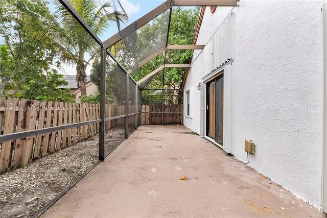 a view of a wooden fence and a pathway