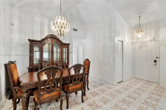 a view of a dining room with furniture and chandelier