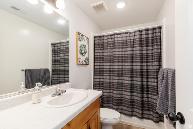 349 West 3085 South Logan, UT 84321 - Photo 25 of 37 Bathroom featuring a wood-finish vanity with a white countertop and integrated sink