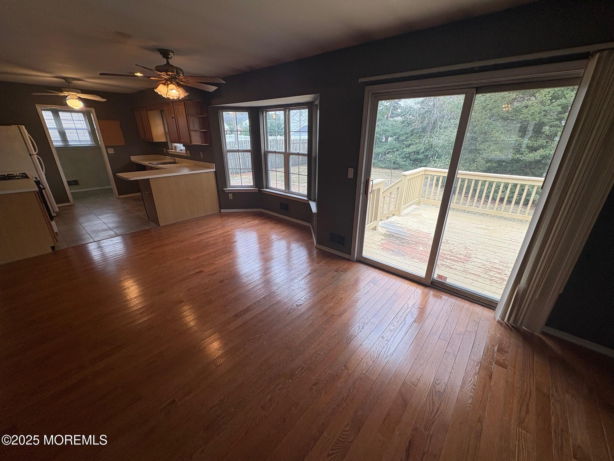 228 Sunset Drive Forked River, NJ 08731 - Photo 5 of 12 a view of an empty room with wooden floor and a window