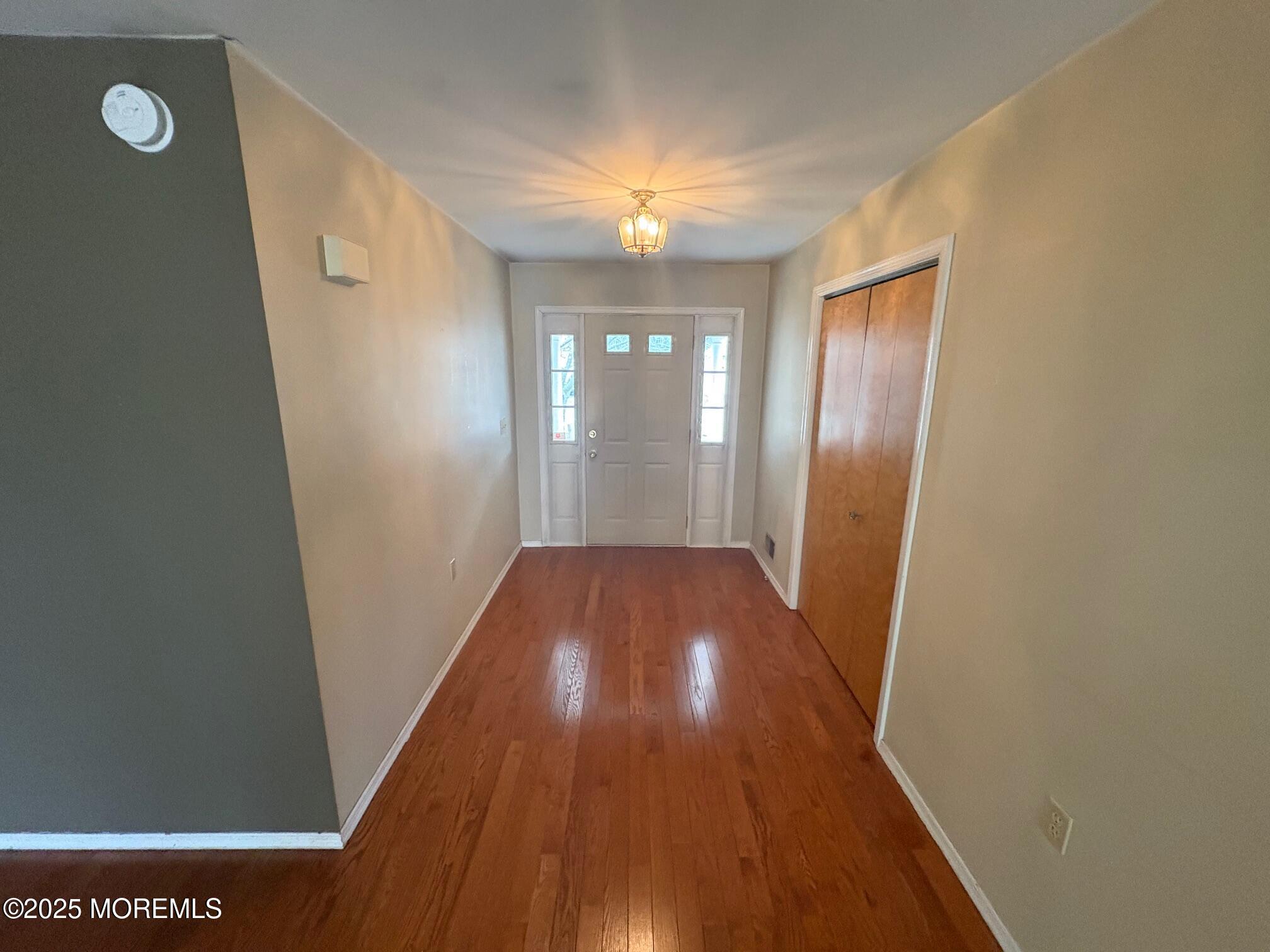 228 Sunset Drive Forked River, NJ 08731 - Photo 7 of 12 a view of a hallway with wooden floor